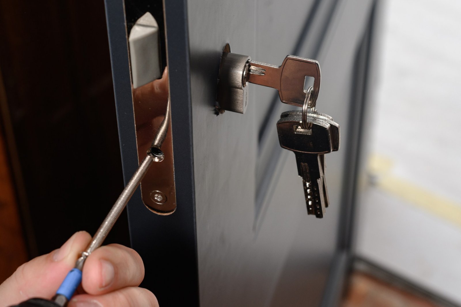 a professional locksmith from Blueline Locksmith in action, expertly handling a commercial lock installation, showcasing reliable and efficient locksmith services for businesses. Keywords: commercial locksmith.