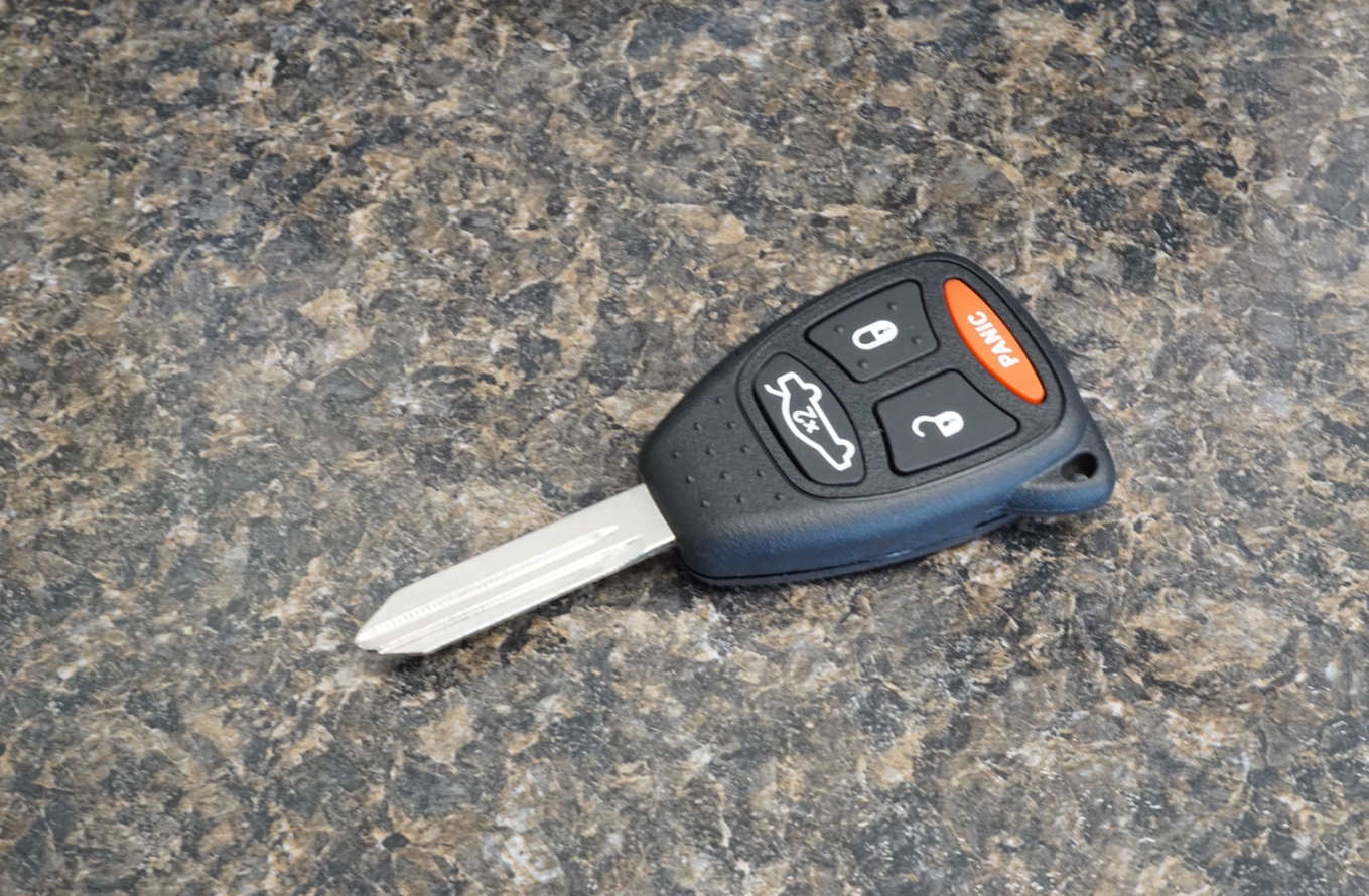 Car key replacement services provided by Blueline Locksmith, featuring a close-up of a professional locksmith working on a vehicle's ignition system.