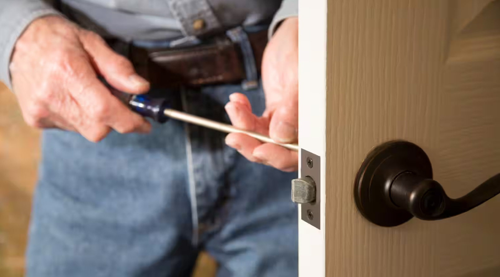 replacing lock by expert technician of Blueline Locksmith.