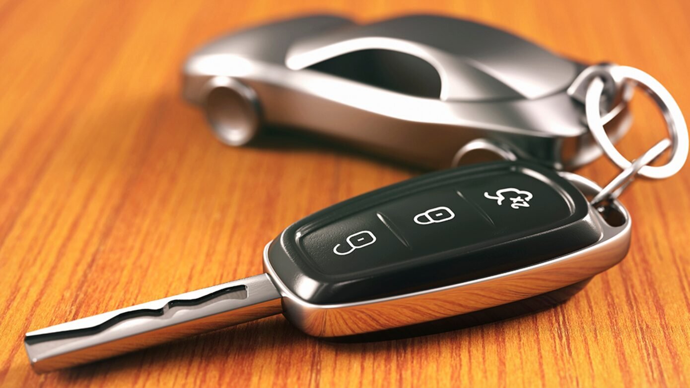 A professional locksmith from Blueline Locksmith, holding a freshly cut car key, ready to replace a customer's lost key, showcasing efficient car key replacement services.